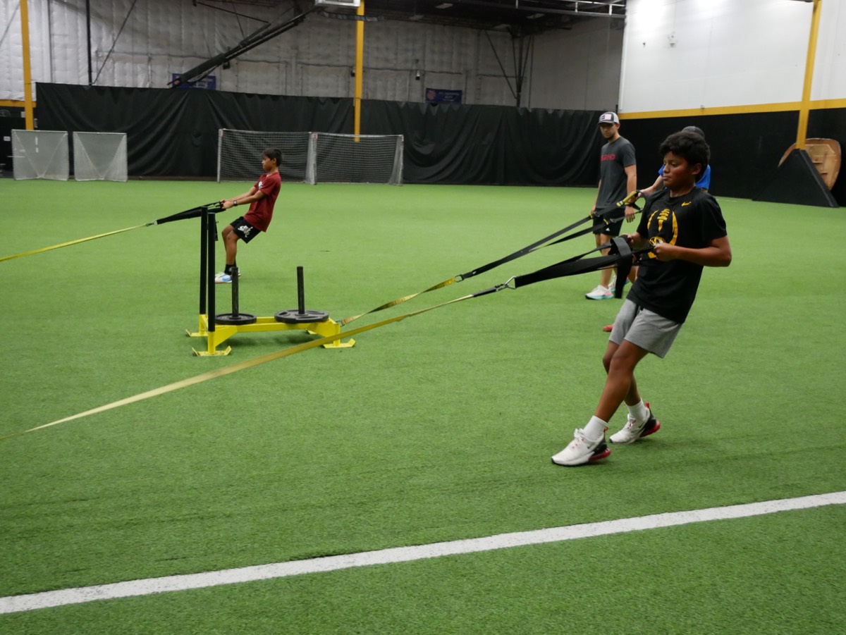 Athletes training on the turf at the Bud Dome